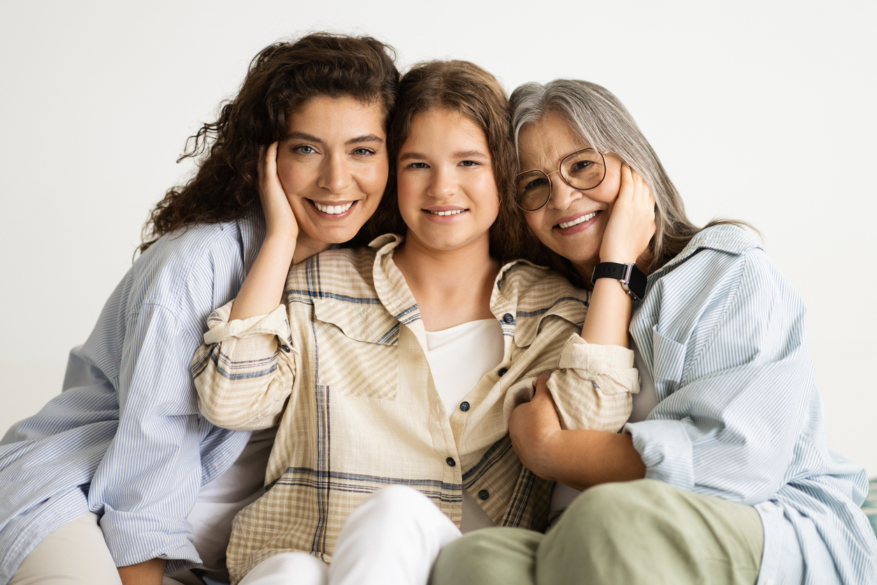 Positive adult, elderly and teenager women and daughter hugging, enjoy free time, isolated on white studio background. Family love, female generation, relationships and visit